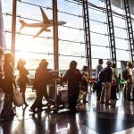 Missile Chaos Cripples Airport – 309 INJURED! Passengers queue inside an airport terminal at sunset