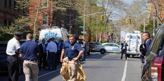 Illegal Alien Wanted For STABBING Cop in Daylight Attack Police officers and investigators at a blocked city street scene