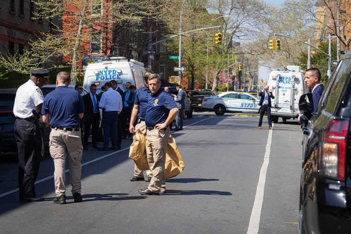 Police officers and investigators at a blocked city street scene