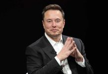 Pentagon Assigns Musk TOP Military Role, Even Gives Him an Office Elon Musk seated in a black suit with hands clasped