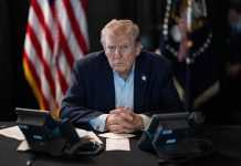 Another Nobel Snub Sparks Trump Fury Donald Trump seated at a table between two desk phones