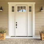 white front door with sidelights and planters