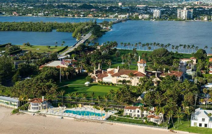 shutterstock_518463952 Aerial view of a waterfront estate with pool, lawns, and palm trees